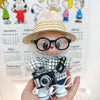 Black plaid shirt + cuffed blue jeans + khaki flat-brim straw hat + black camera + black-rimmed glasses + white canvas shoes